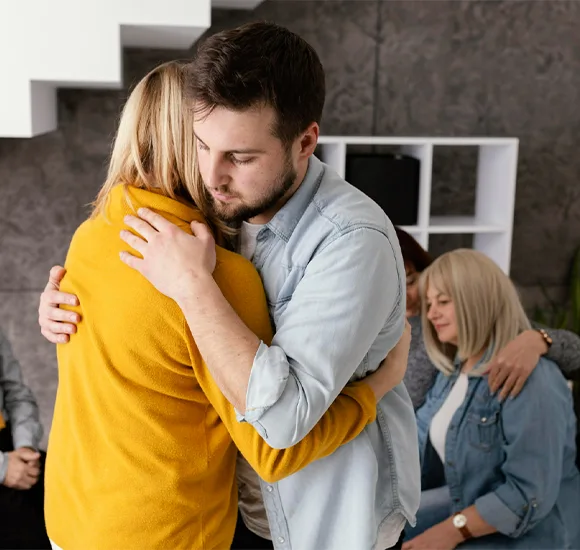 group therapy session with hugs